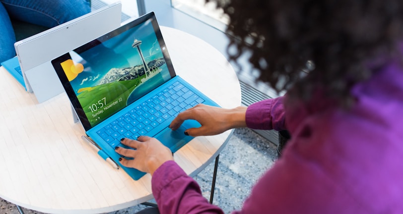 woman in purple sweater using laptop