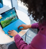 woman in purple sweater using laptop