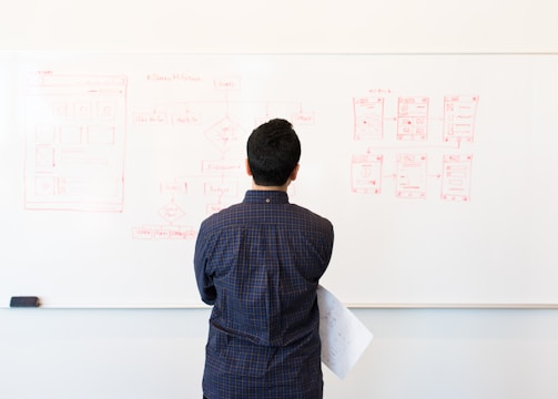 man standing near whiteboard